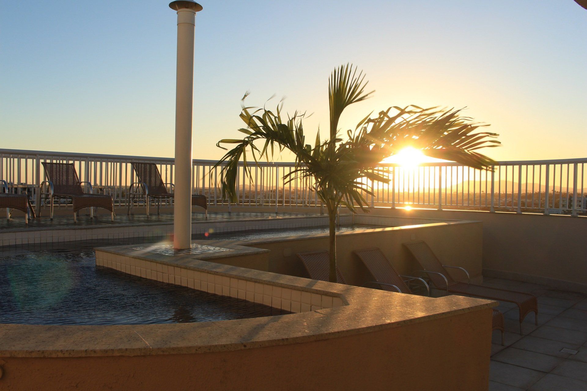 Rooftop pool at sunset at Green Hotéis